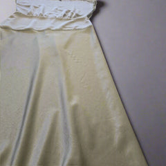 Olive fabric draped over a surface with tiled floor in the background