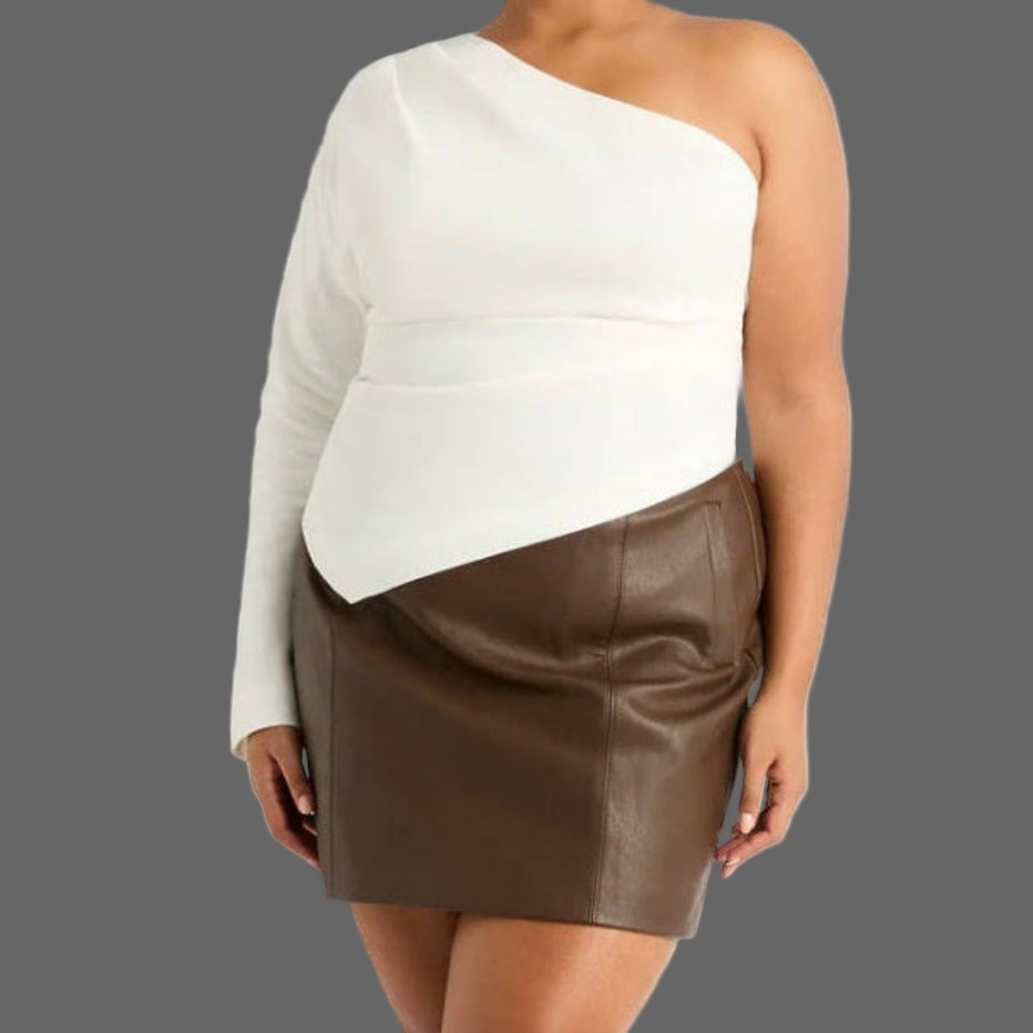 Woman wearing a one-shoulder white top and brown skirt on a white background