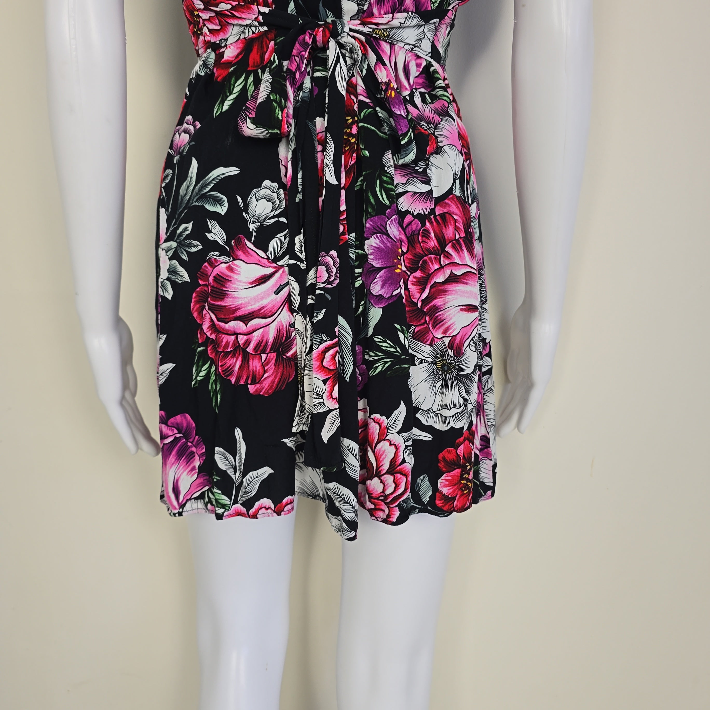 Floral dress with pink and black flowers on a white mannequin.