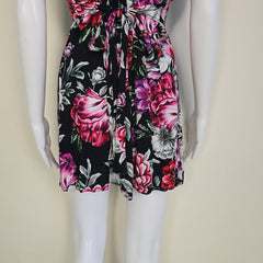 Floral dress with pink and black flowers on a white mannequin.
