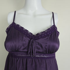 Purple lace top on a mannequin against a plain background