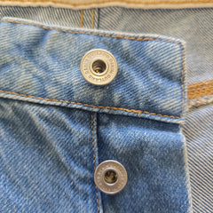 Close-up of a denim jacket with buttons and plaid pattern