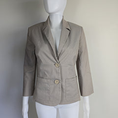 Beige jacket on a mannequin against a white background