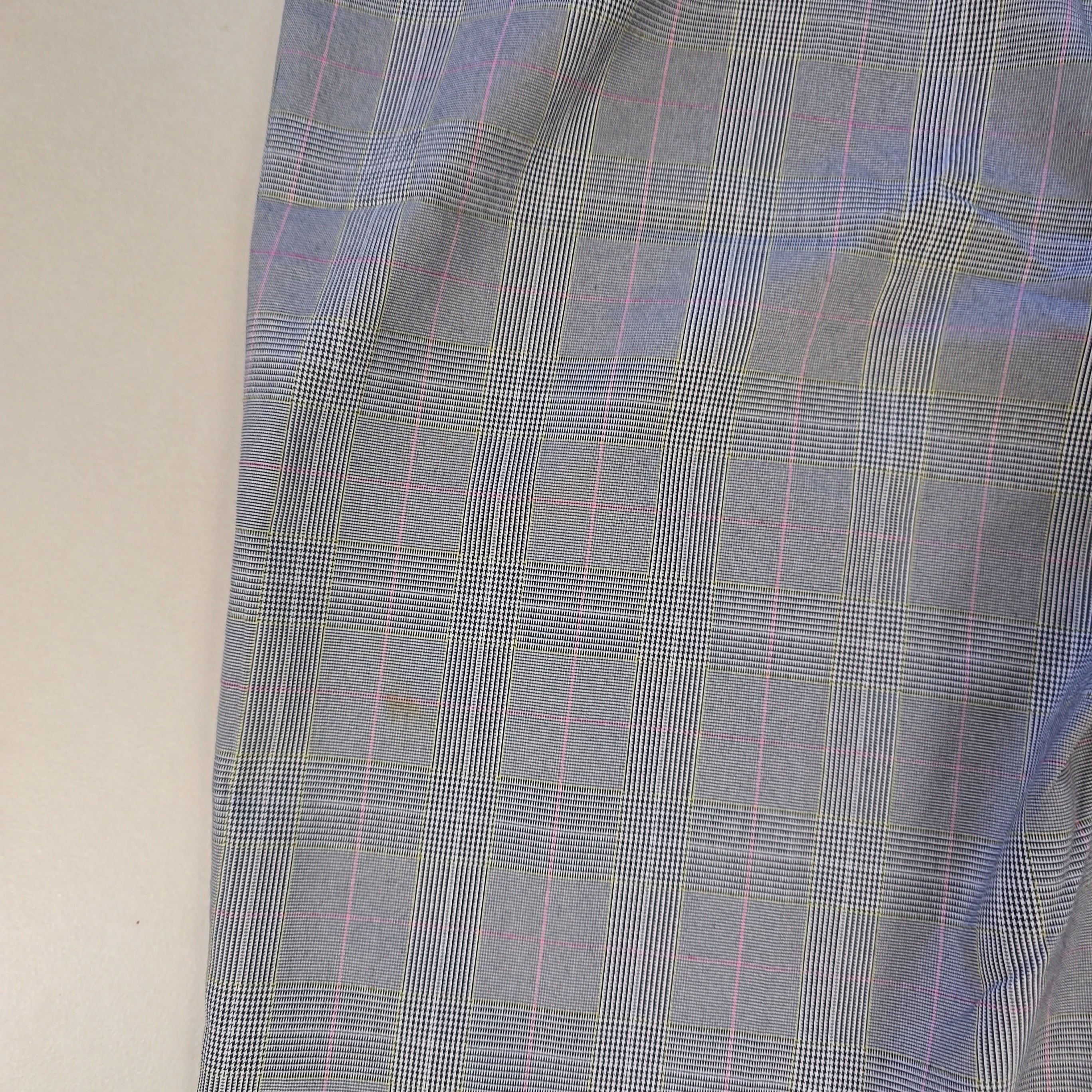 Plaid fabric with blue and pink lines on a plain background