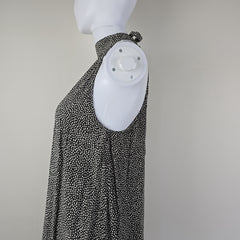 Grey and white spotted patterned dress on a light background