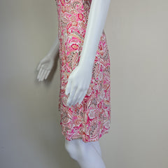 Mannequin arm with a pink patterned skirt on a plain background