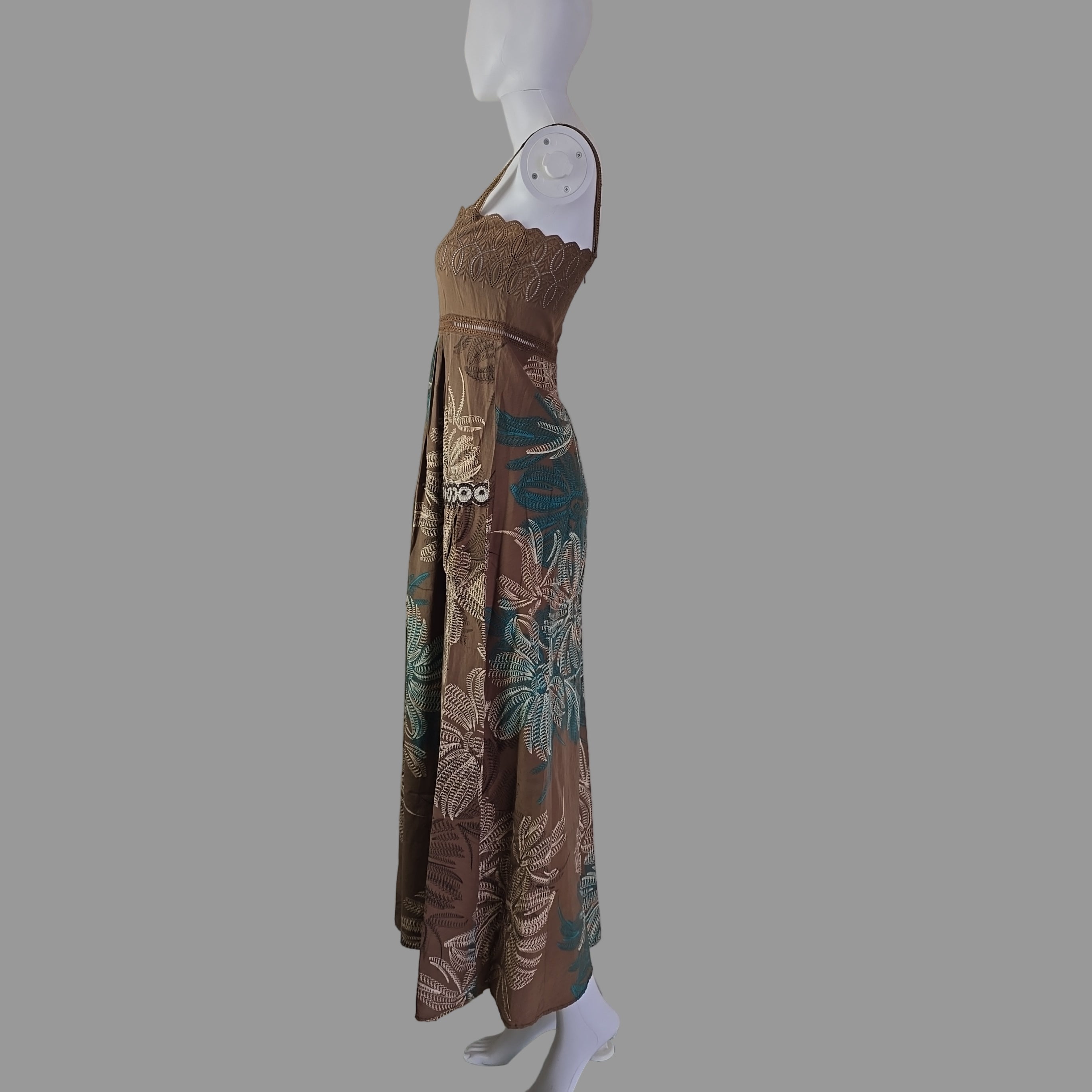 Folded floral dress on a mannequin against a white wall