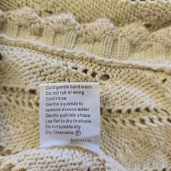 Close-up of a knitted fabric with a care label attached