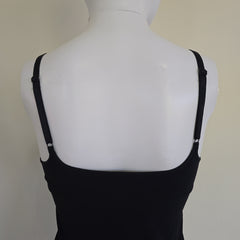 Black top on a mannequin with a plain background