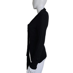 Black top with tie detail on a light background