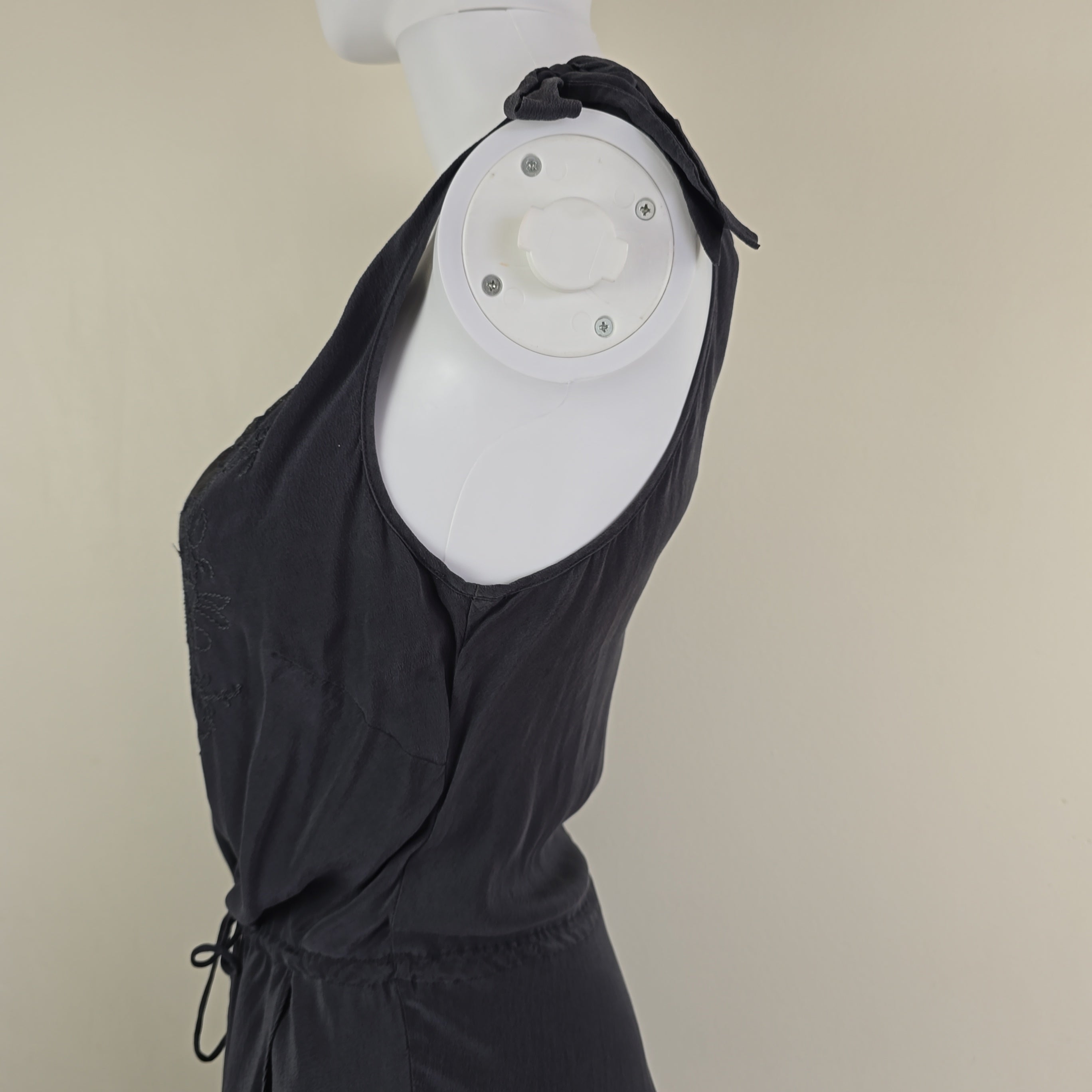 Grey dress against a beige background