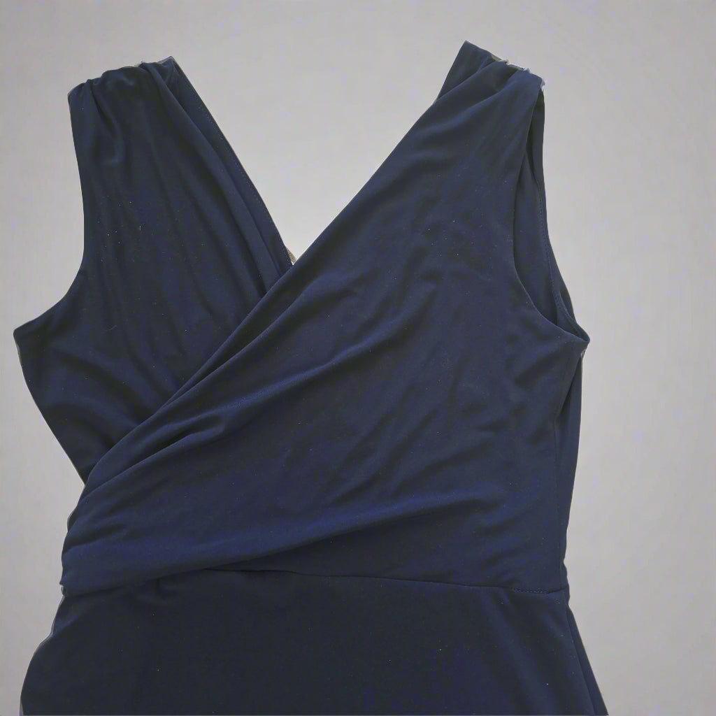 Navy blue dress with a draped design on a light gray background