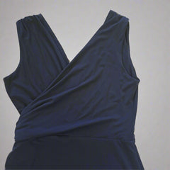 Navy blue dress with a draped design on a light gray background