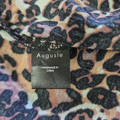 Leopard print fabric with 'Auguste' label on a multicolored background