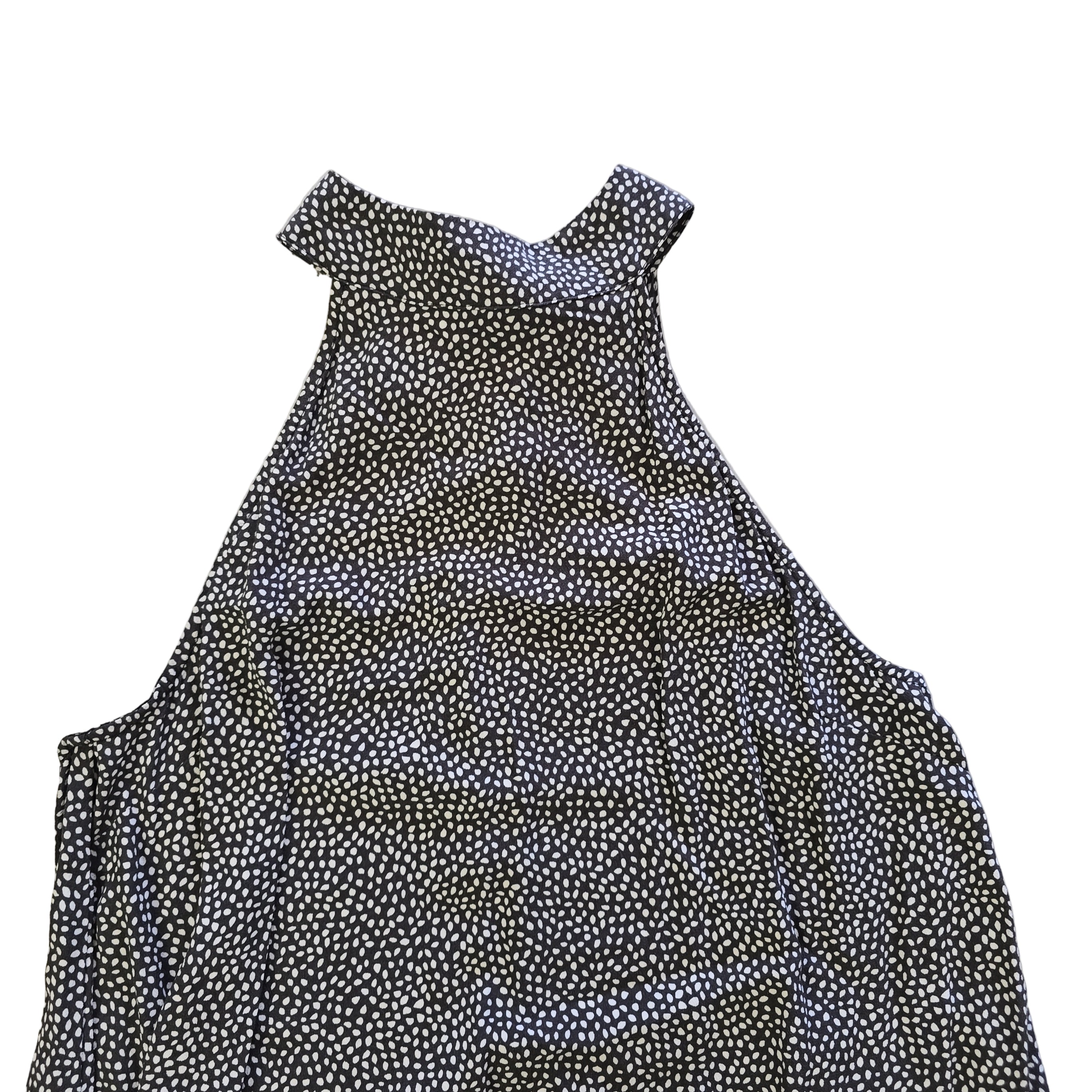 Grey and white spotted patterned dress on a light background