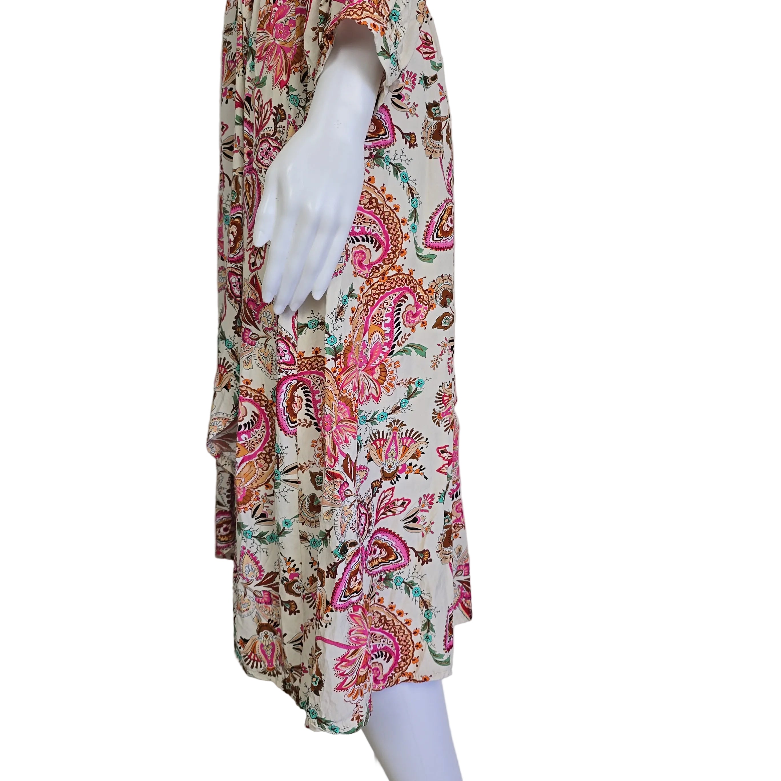 Floral-patterned dress on a mannequin arm against a plain background