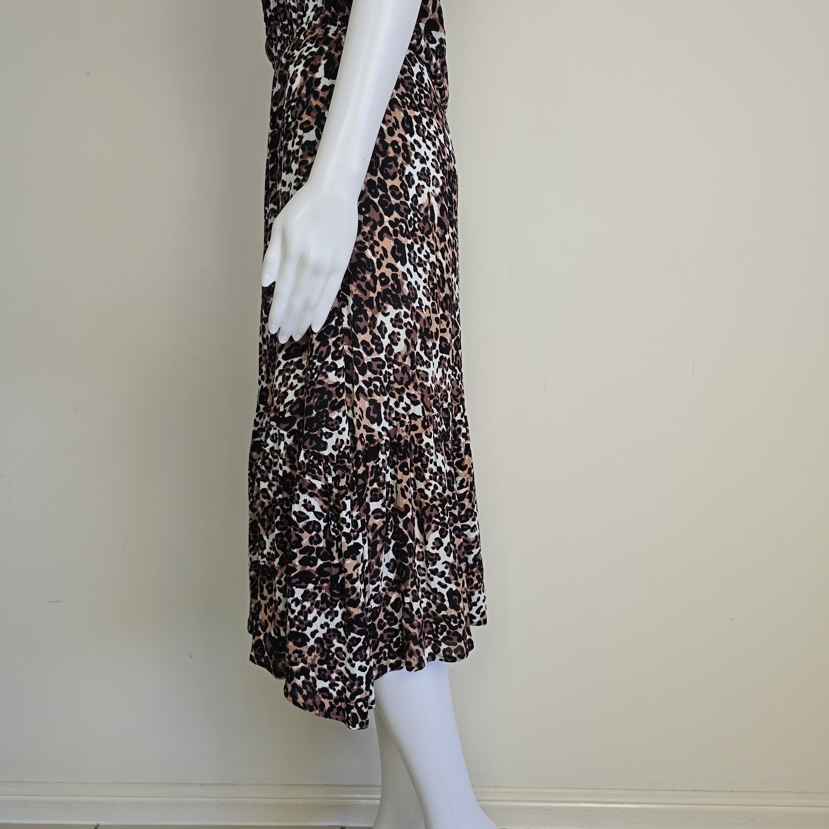 Leopard print dress on a mannequin against a plain background