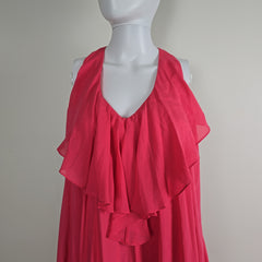 Mannequin wearing a bright pink dress with a plain background