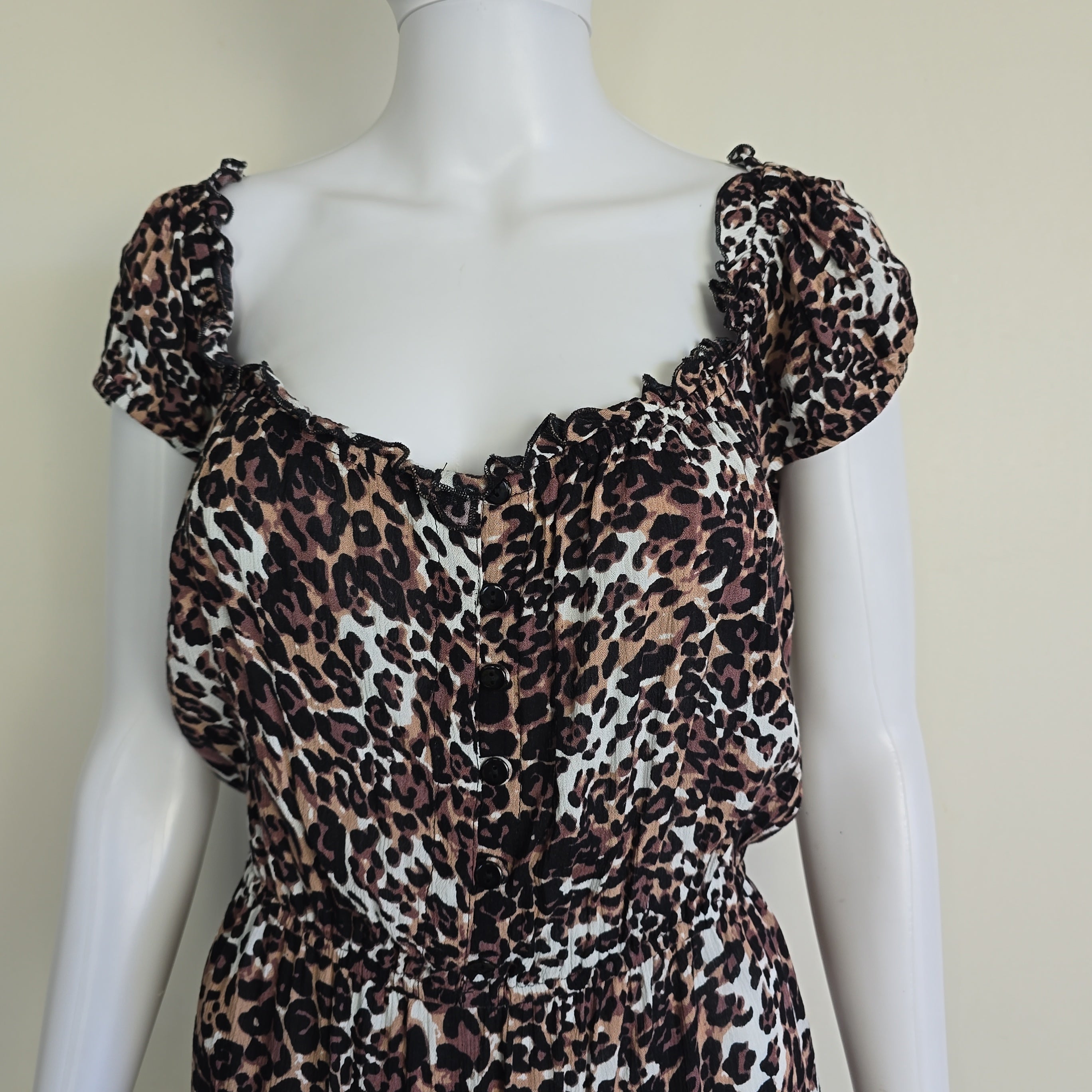 Mannequin wearing a leopard print outfit with a beige background