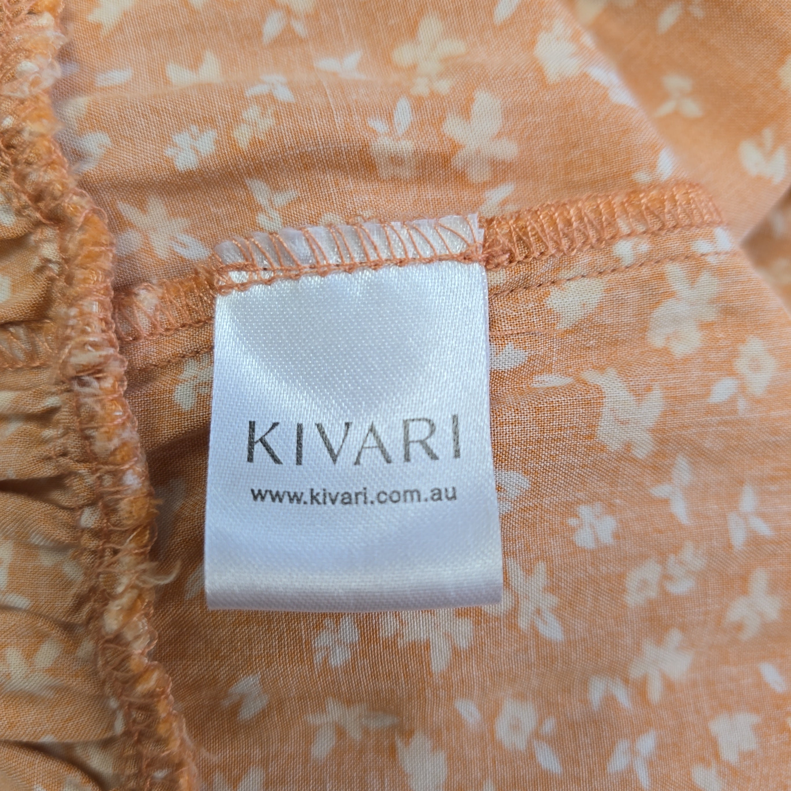 KIVARI label on a floral fabric background