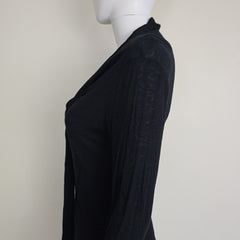 Black top with tie detail on a light background