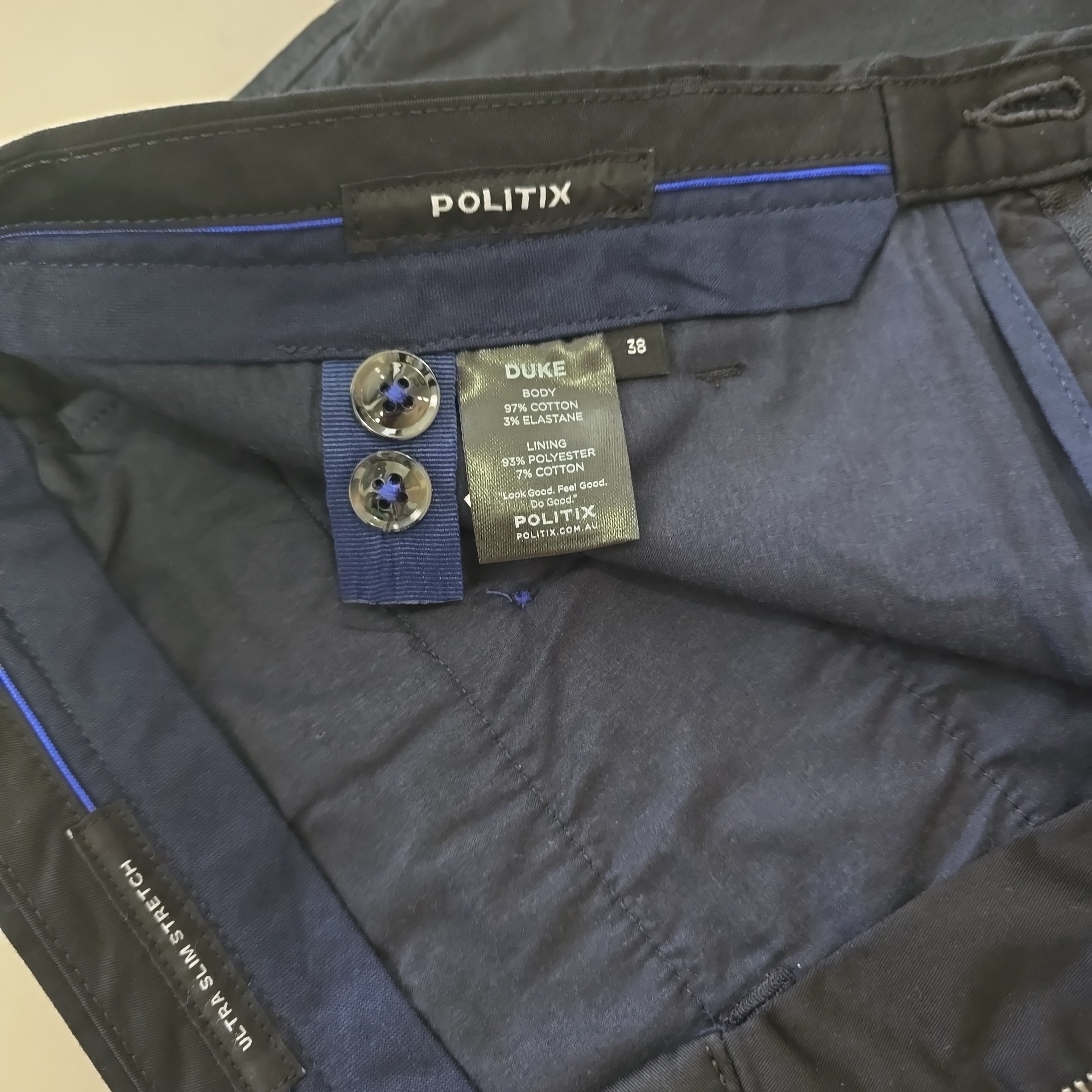 Close-up of pants with visible brand labels and buttons.
