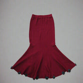 Red skirt with black accents on a plain background