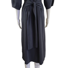 Grey dress on a mannequin against a beige wall