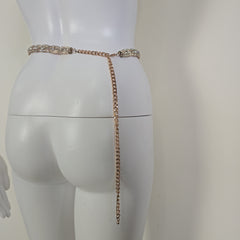 Rose gold belt with crystals on a white mannequin