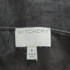 Witchery label on a dark fabric background