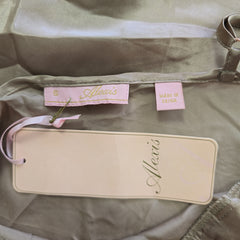 Alexis brand and size tag on beige silk background