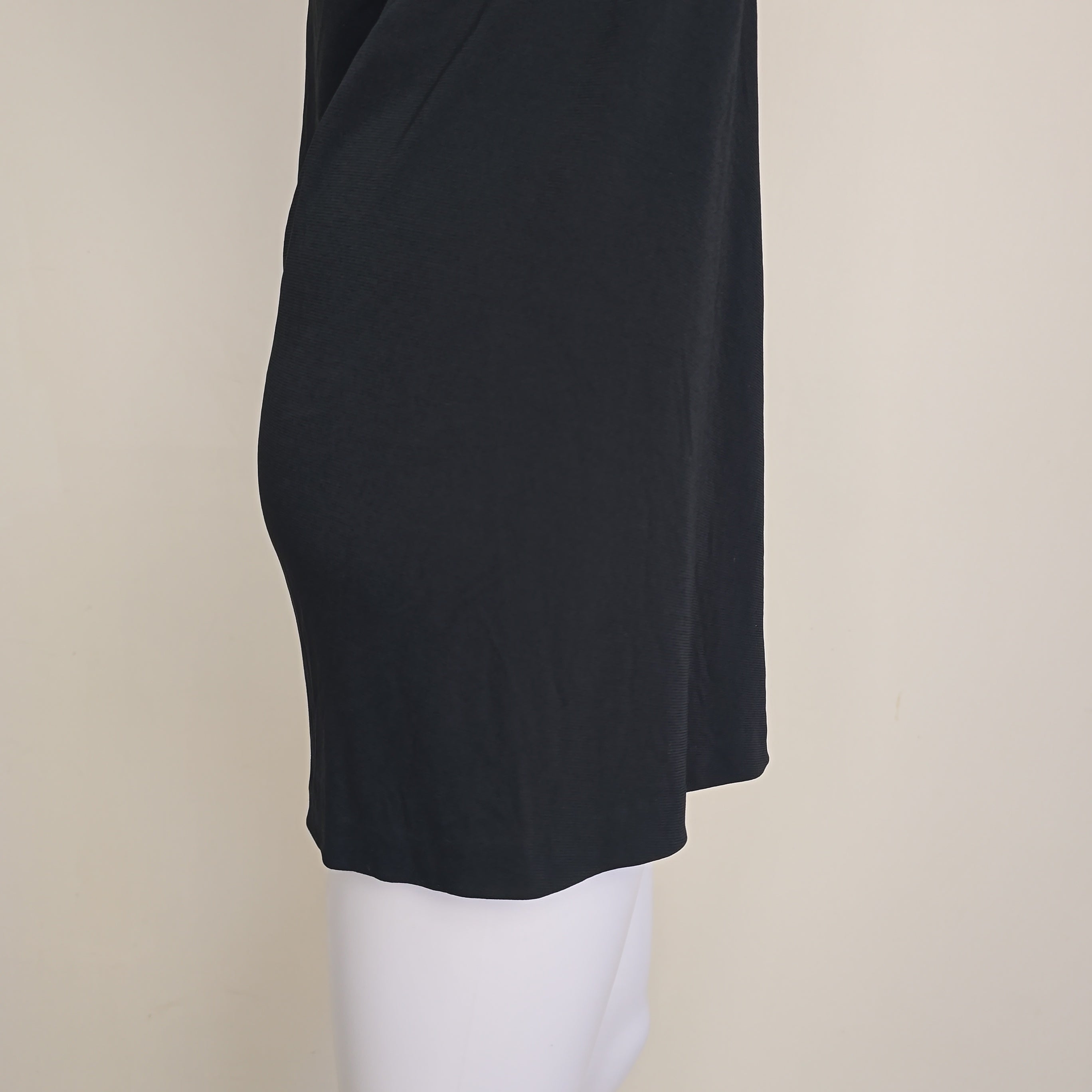 Black mini dress on a light background