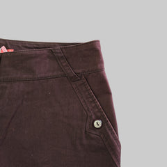 Close-up of a brown fabric with a button on a light gray background