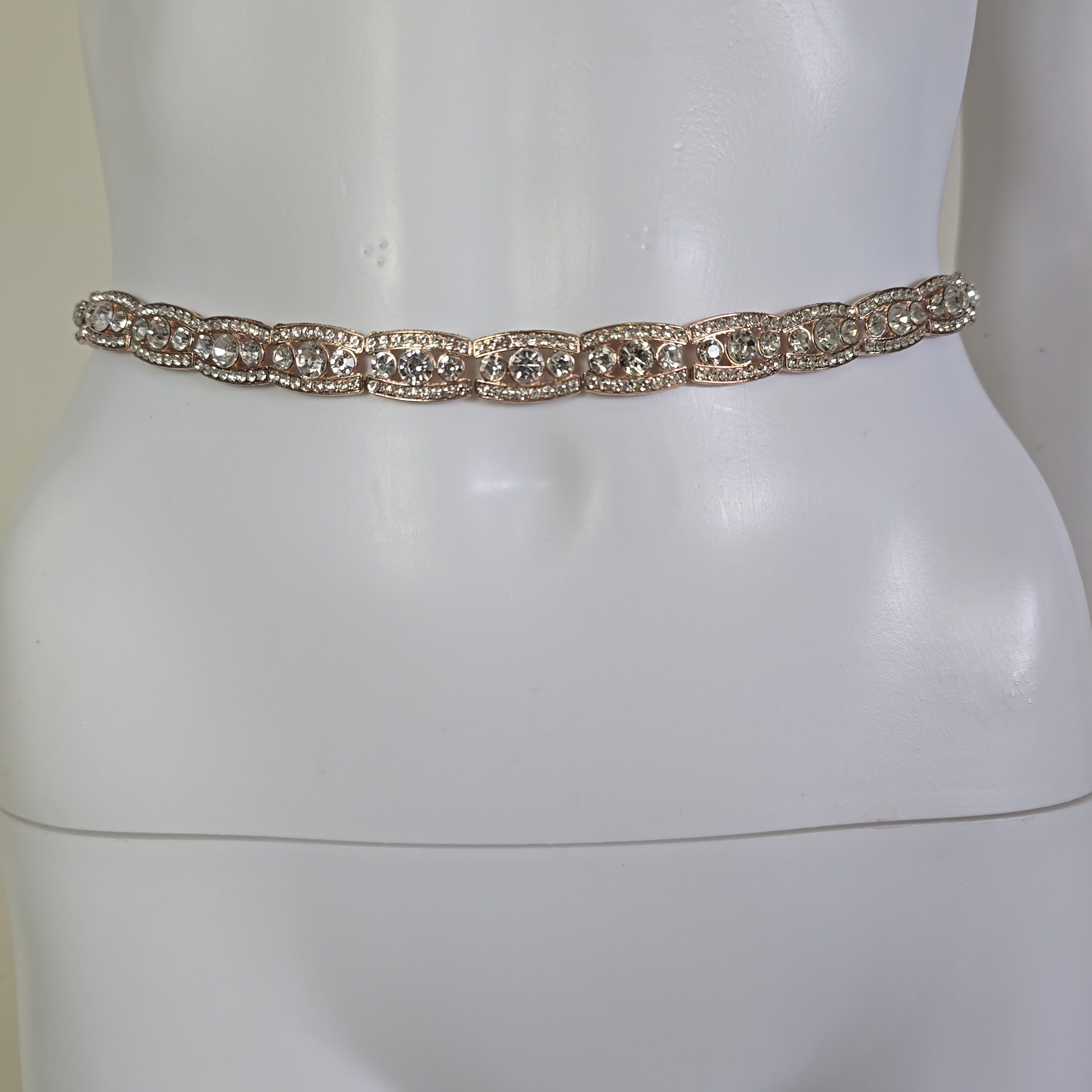 Gold belt on a mannequin against a white background