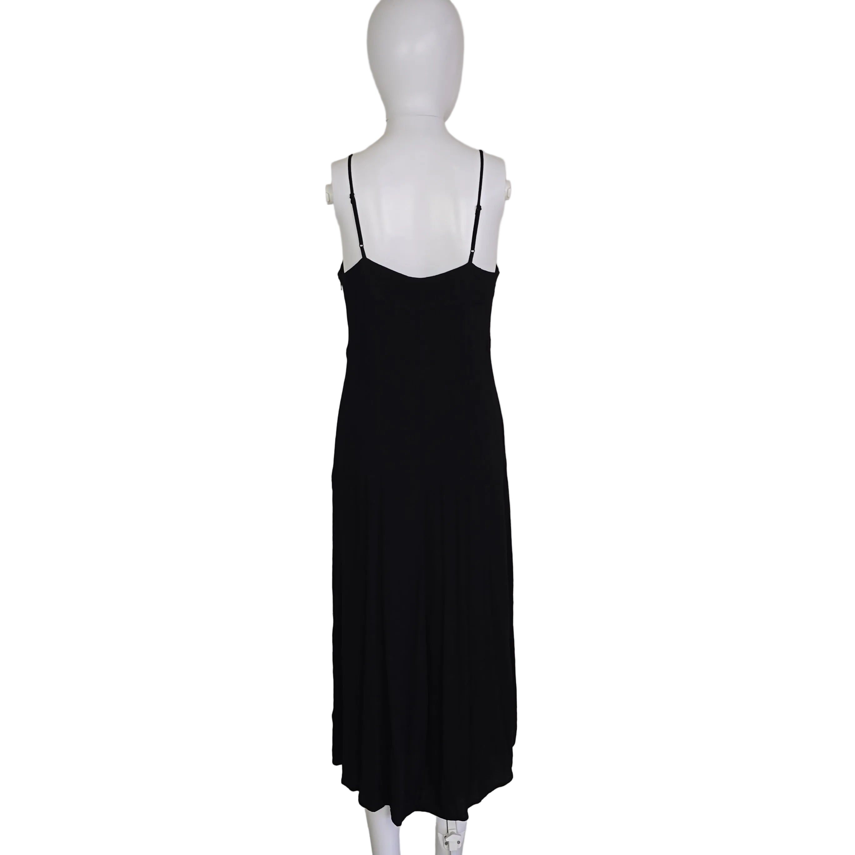 Black dress on a mannequin against a plain background