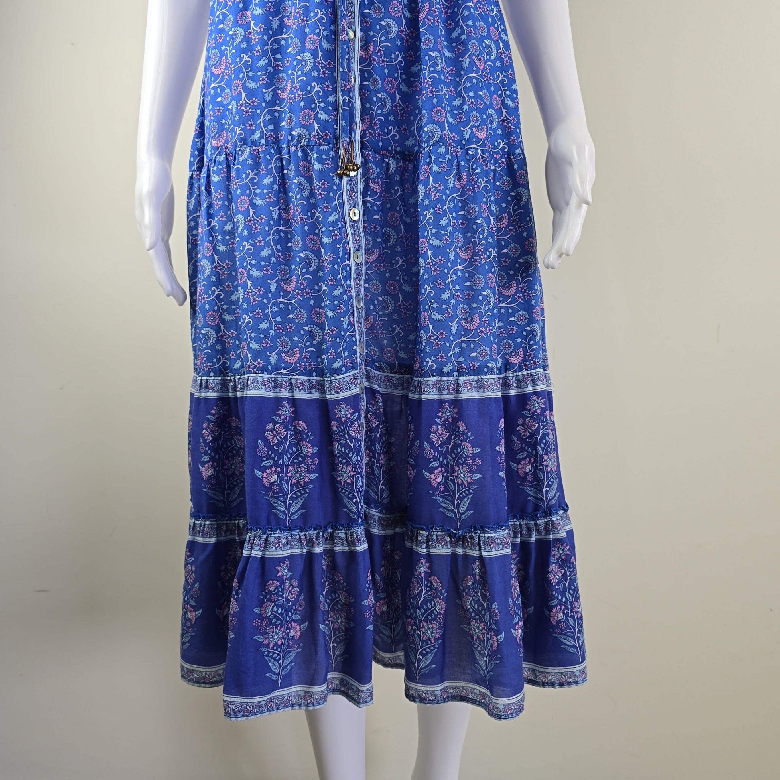 Blue patterned dress on a mannequin against a plain background