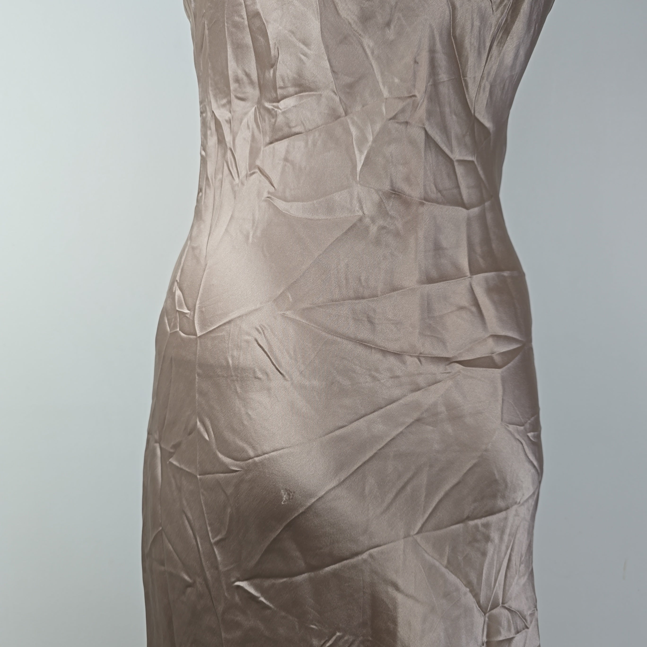 Brown crumpled fabric on a light gray background