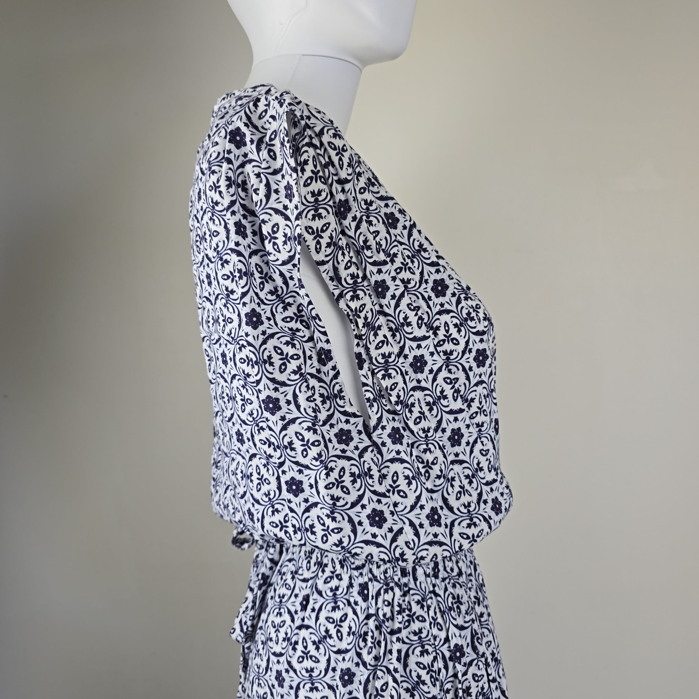 Mannequin wearing a patterned outfit with a plain background