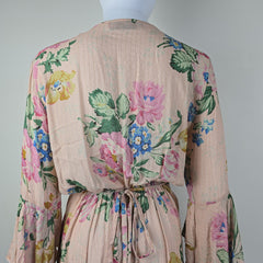 Floral-patterned fabric with pink, blue, and green colors on a light gray background