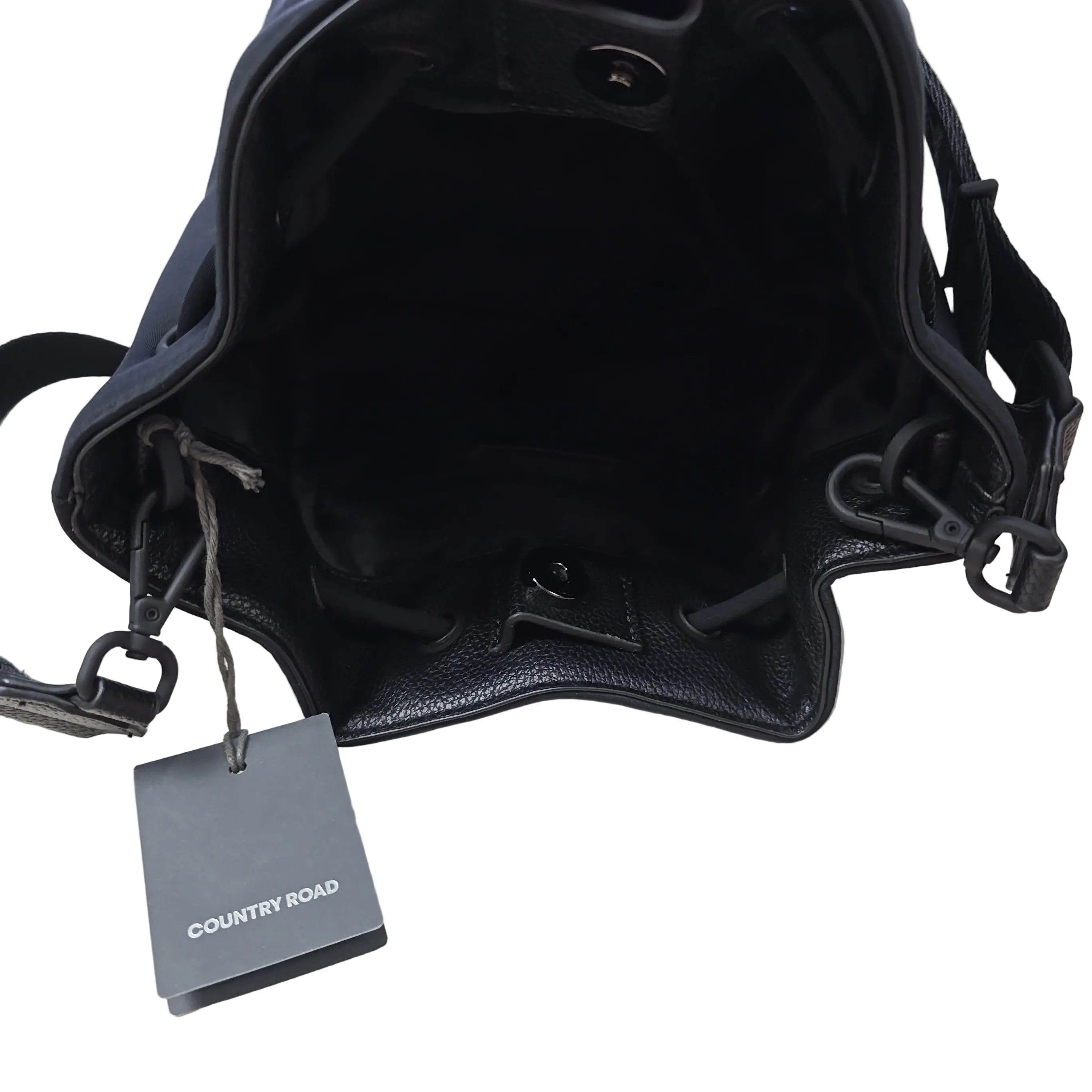 Black leather bag with a visible brand tag on a light background