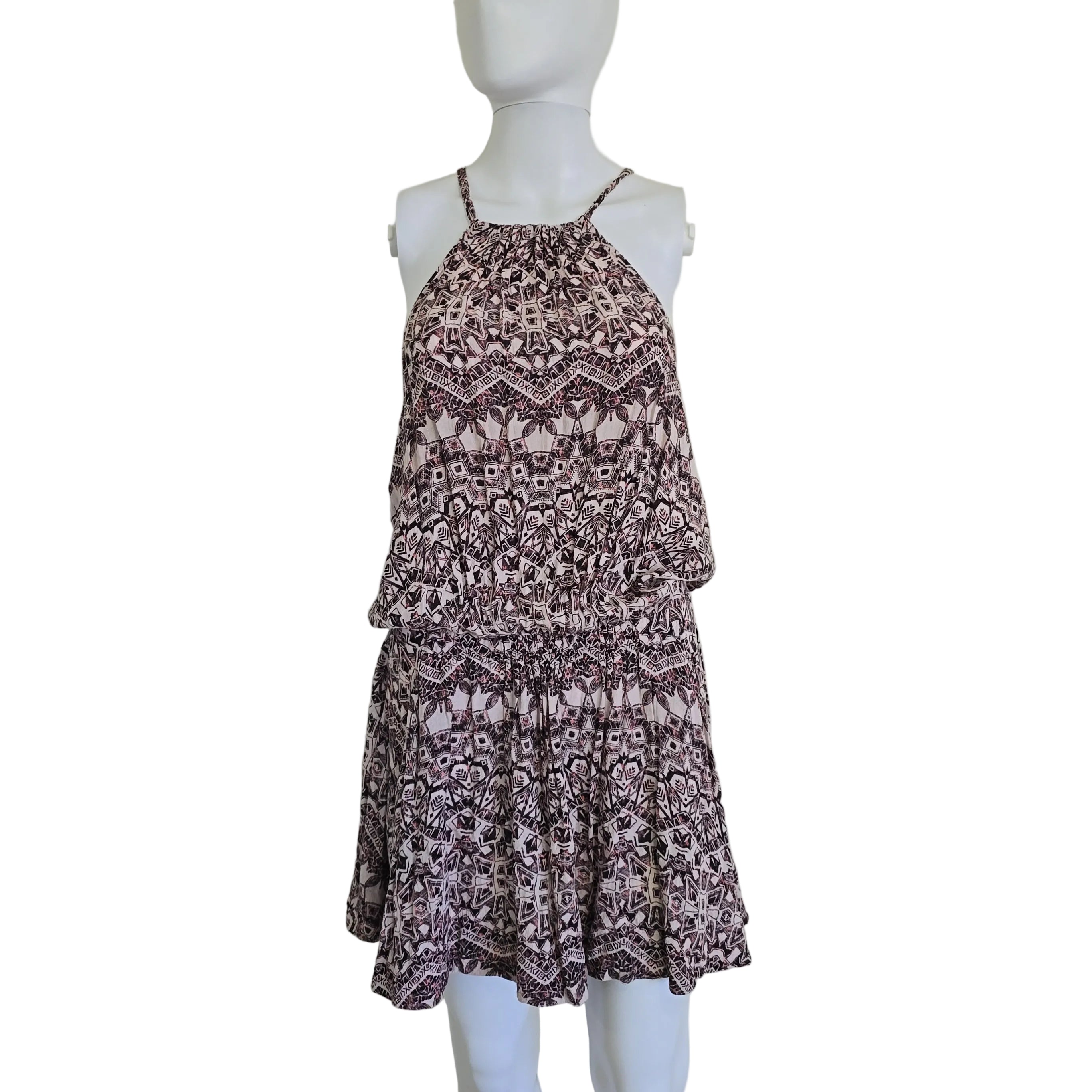 Patterned dress on a mannequin against a plain background