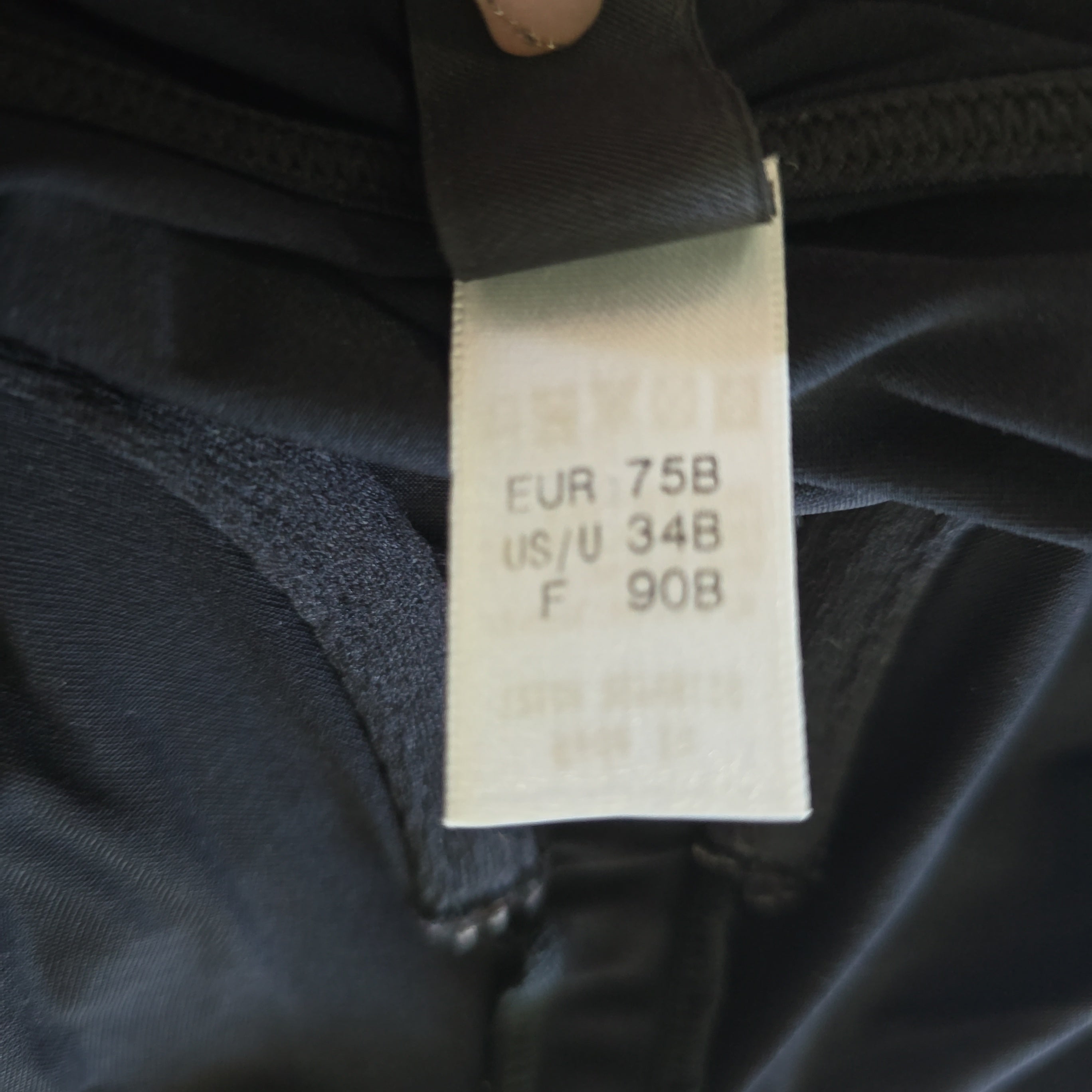 Clothing tag on a dark fabric background