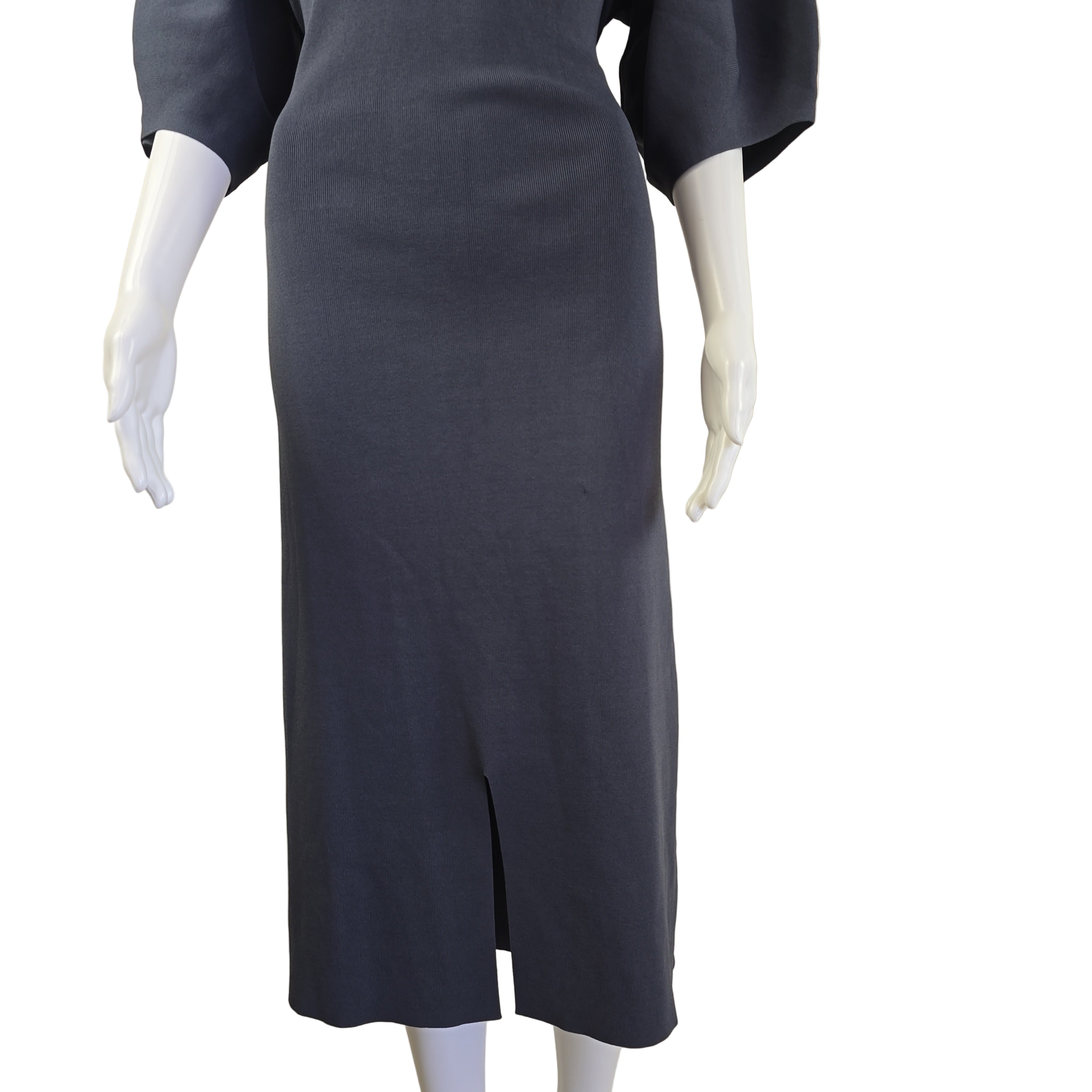 Mannequin legs wearing dark dress on a beige background