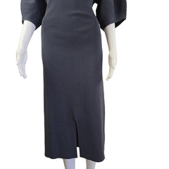 Mannequin legs wearing dark dress on a beige background