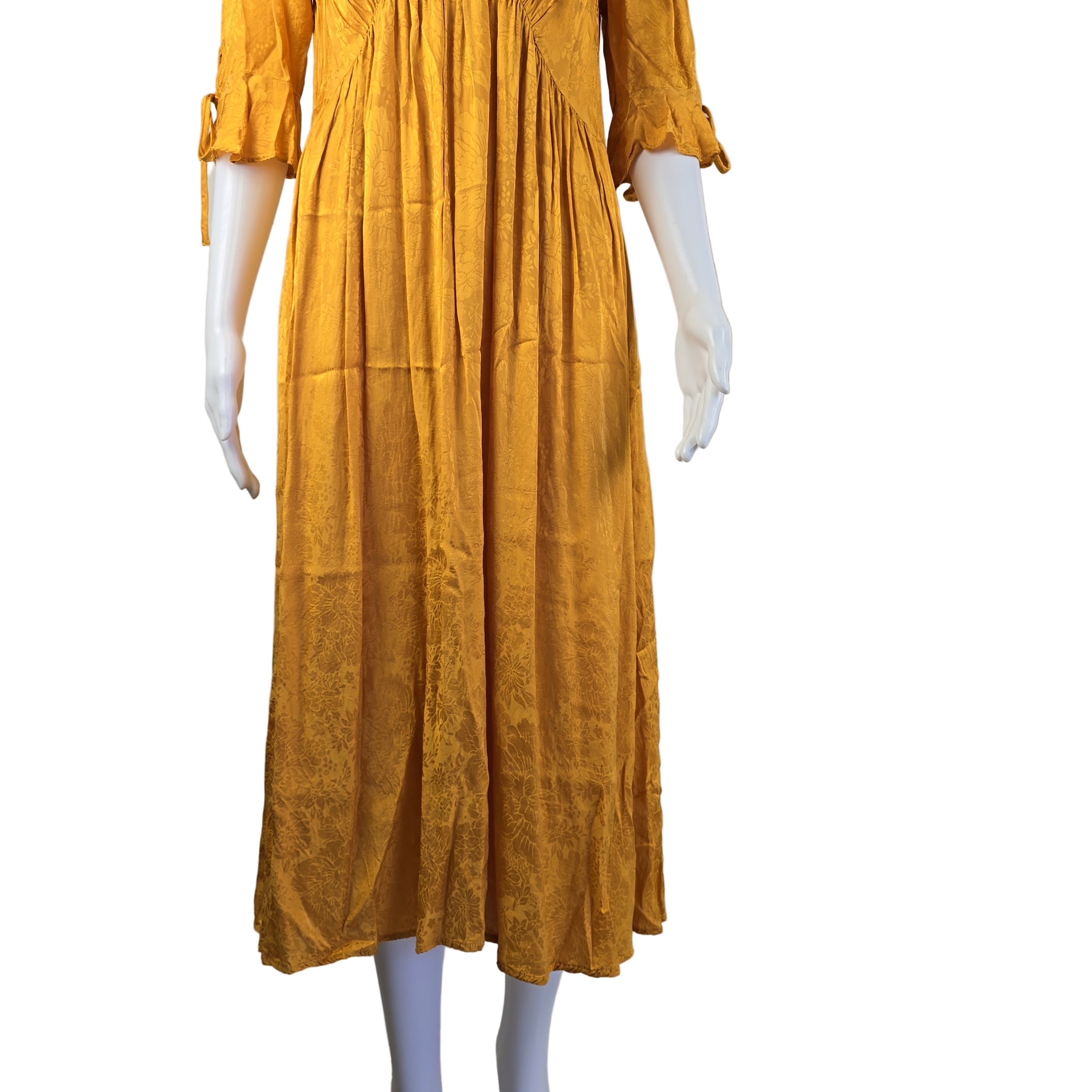 Yellow dress on a mannequin against a plain background