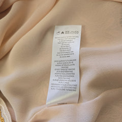 Clothing label on a beige fabric background