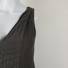 Dark gray fabric draped over a mannequin on a light gray background