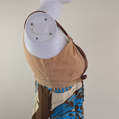 Mannequin wearing a patterned dress on a plain background