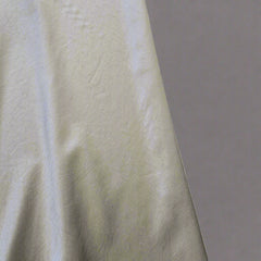 Close-up of a textured fabric with a tiled background