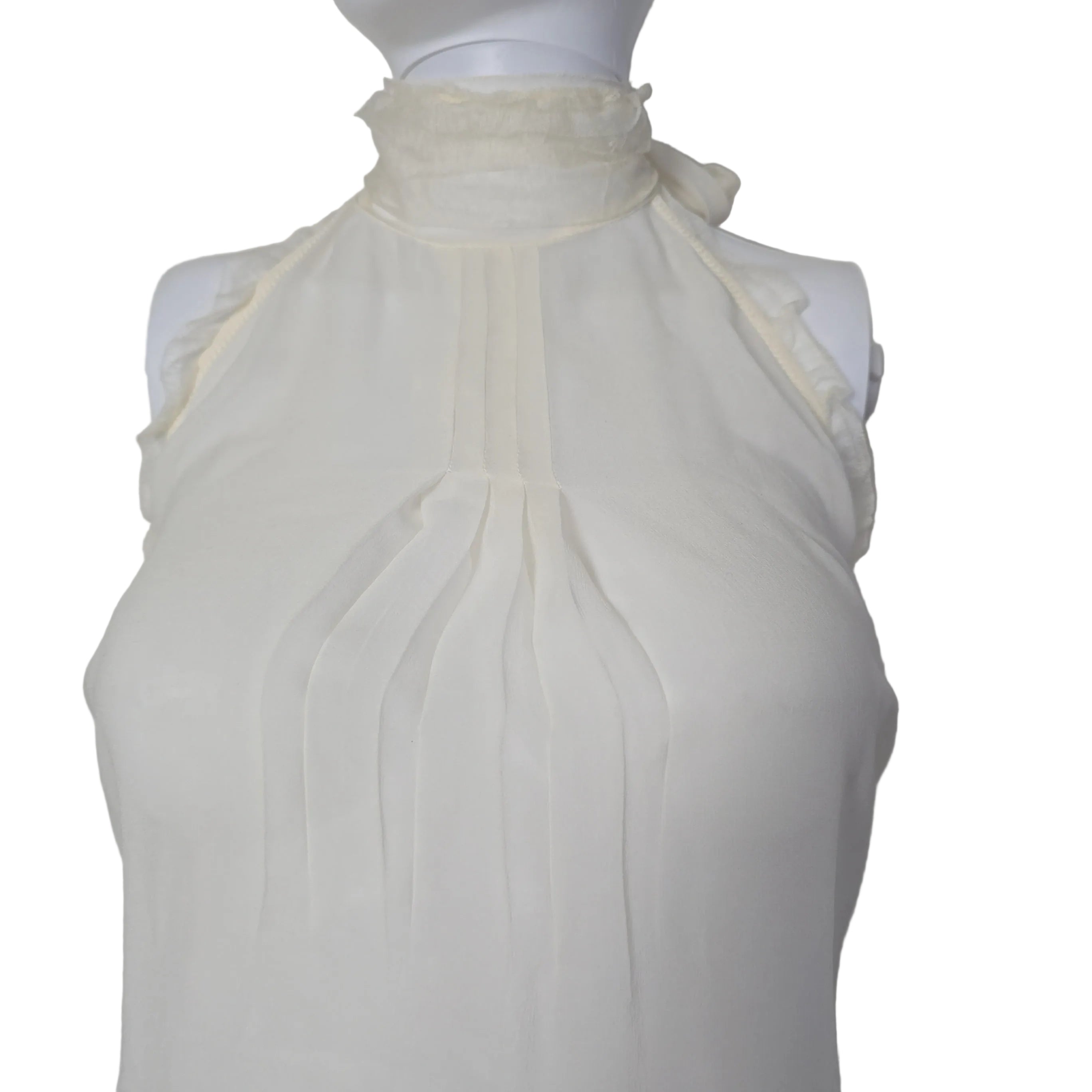 White top with lace details on a white background